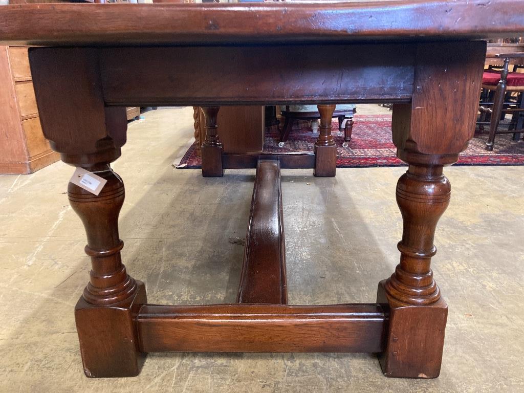 An 18th century style oak refectory dining table, length 228cm, depth 91cm, height 76cm